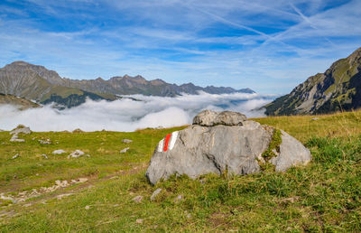 Scenic view of rocks on field against sky