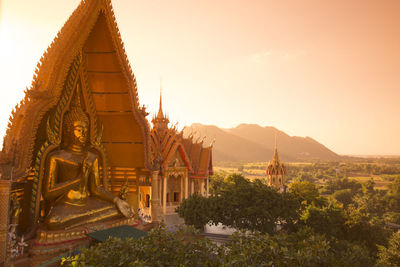 Buddha temple against sky during sunset