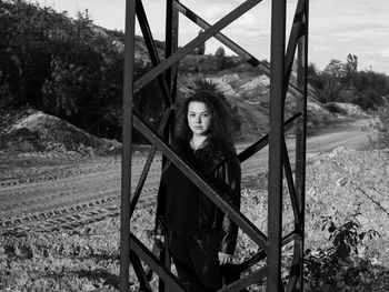 Portrait of beautiful young woman standing on land