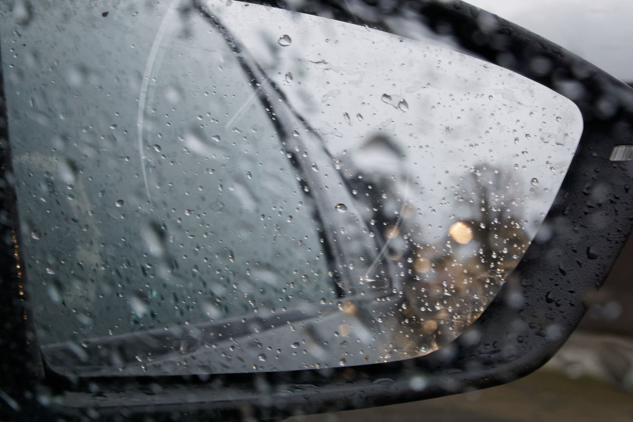 CLOSE-UP OF RAINDROPS ON WINDOW GLASS