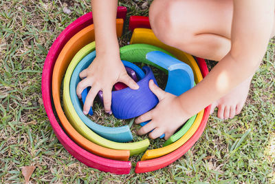 Low section of boy playing with toys