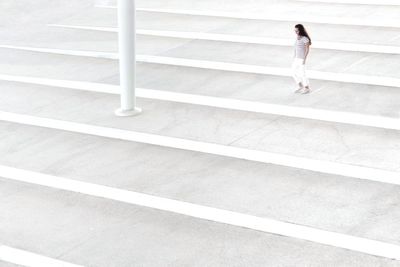 High angle view of woman walking on staircase