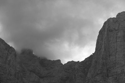 Low angle view of cliff against sky