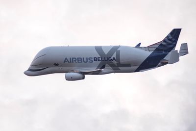 Low angle view of airplane flying against sky