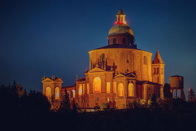 Low angle view of illuminated building against sky at night