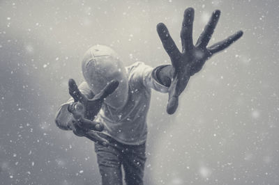 High angle view of man gesturing in snow