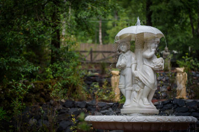 Statue against trees