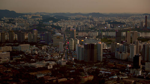 High angle view of modern buildings in city against sky