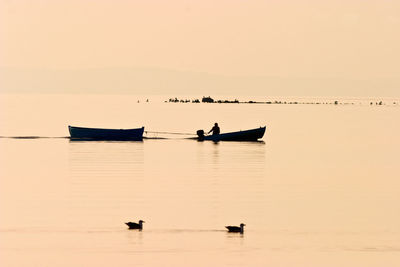Fisherman in a pleasure boat at sunset