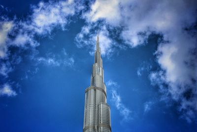 Low angle view of building against cloudy sky