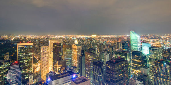 High angle view of illuminated buildings against sky in city