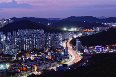 High angle view of illuminated city buildings at night