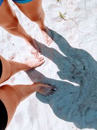 Low section of woman standing on beach