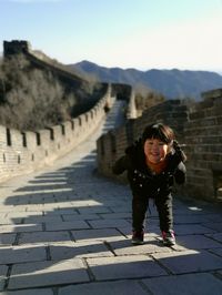 Portrait of happy young woman against clear sky