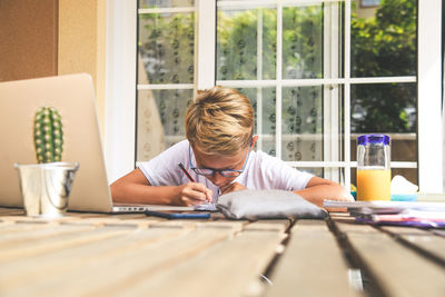 Portrait of boy sitting on table