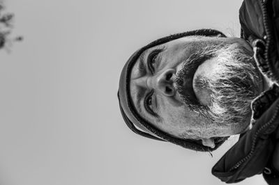 Close-up portrait of man against white background