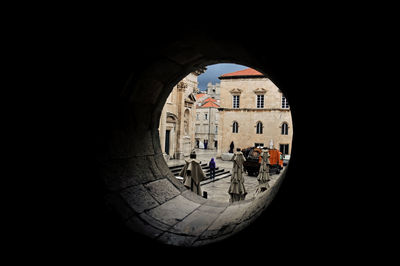 Buildings seen through hole of building