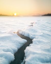 Scenic view of frozen sea against sky during sunset