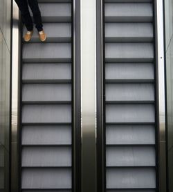 Low section of man on escalator