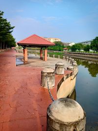 Built structure by lake against sky