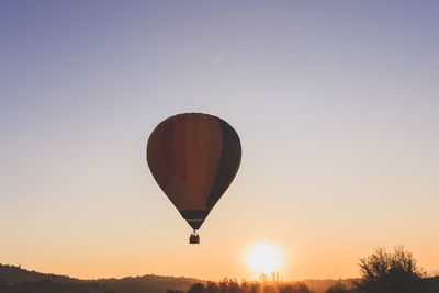 Low angle view of hot air balloon against sky during sunset