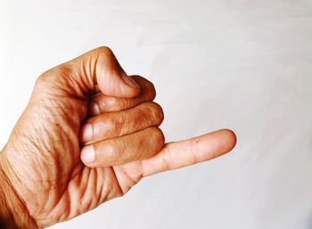 Close-up of hands over white background