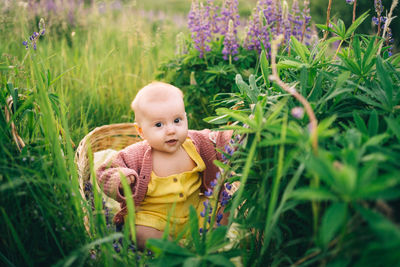 Portrait of young woman sitting on field