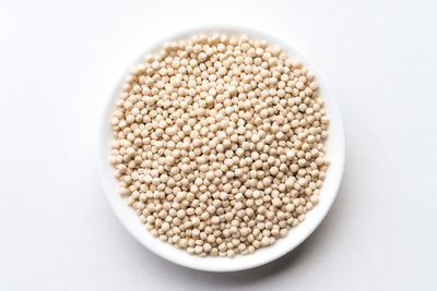 High angle view of seeds in bowl on white background