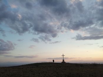 Silhouette tower on land against sky during sunset
