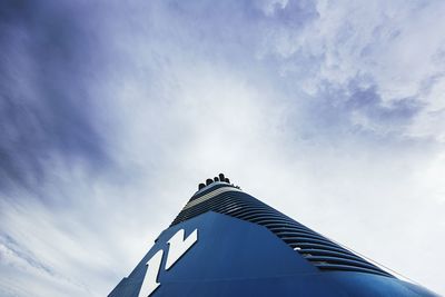 Low angle view of tower against blue sky