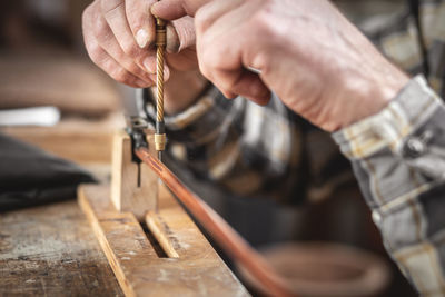 Midsection of person working on wood