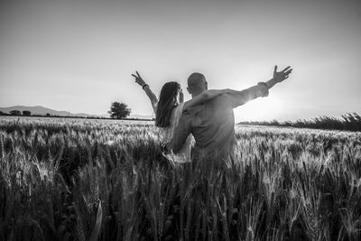 Low angle view of person standing on field against sky