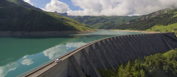 Scenic view of the dam and lake roseland by mountains against sky in the french alpes