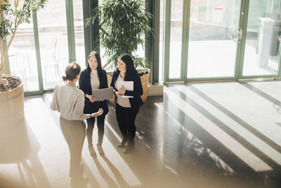 High angle view of multi-ethnic businesswomen discussing during conference at office