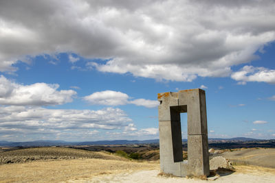 Old ruin on field against sky