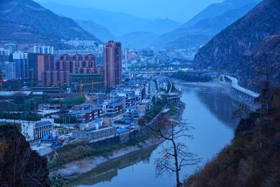 Aerial view of river and cityscape against sky