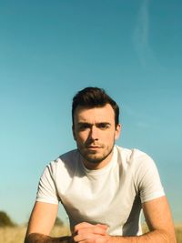 Portrait of man against blue sky