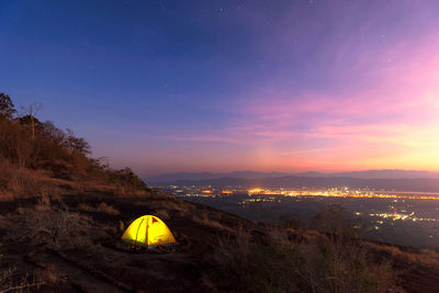 Scenic view of illuminated mountain against sky at night