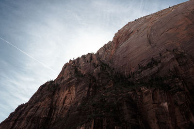 Low angle view of rocky mountains against sky