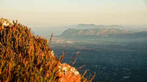 Scenic view of sea and mountains against sky