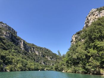 Scenic view of mountains against clear blue sky