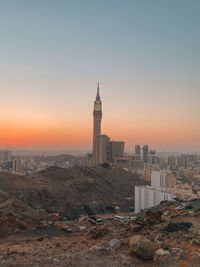 Buildings in city at sunset