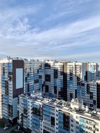 Aerial view of buildings in city against sky