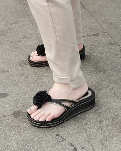Low section of man standing on footpath