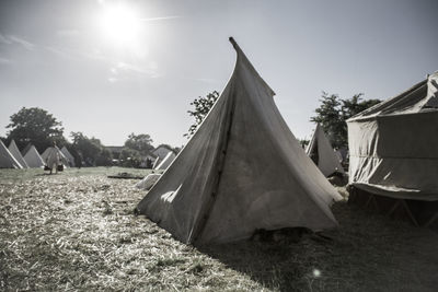 Tent on field against sky on sunny day