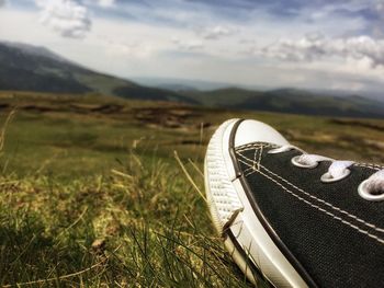 Close-up of shoes on field