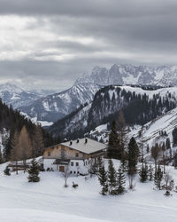 Hut in the mountains. view of scenic winter landscape and snowy mountains. bad weather is coming.