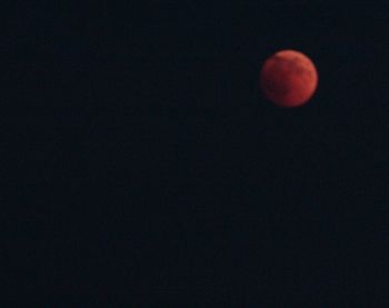 Low angle view of moon against sky at night