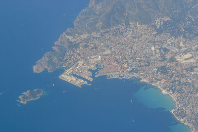 High angle view of city lit up at seaside