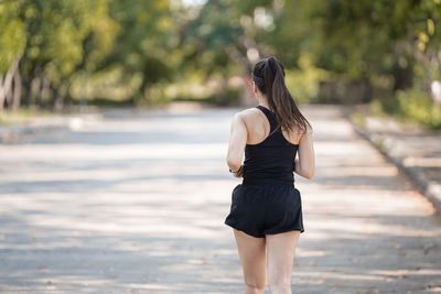 Rear view of woman standing on land